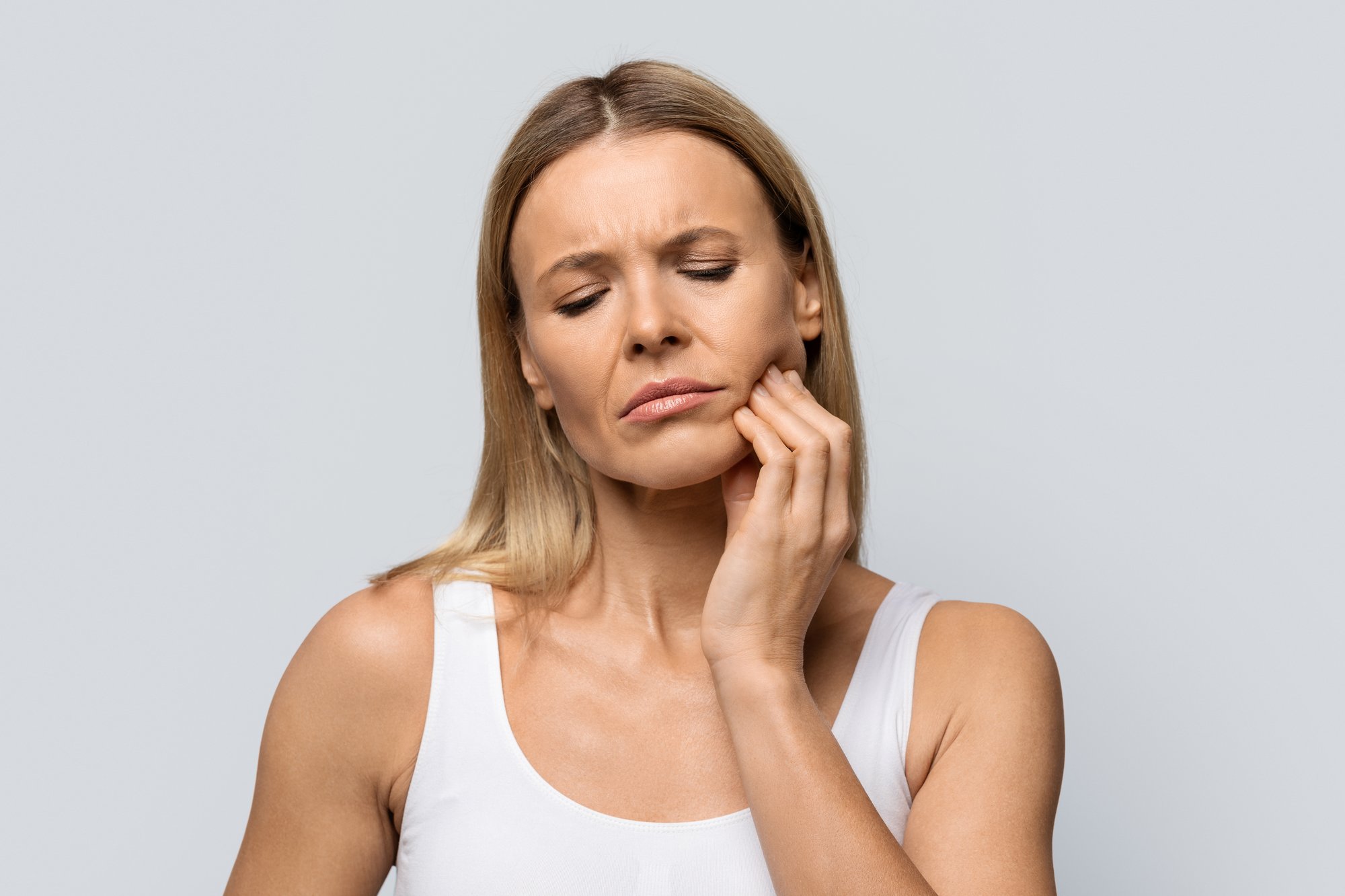 Woman experiencing TMJ Discomfort